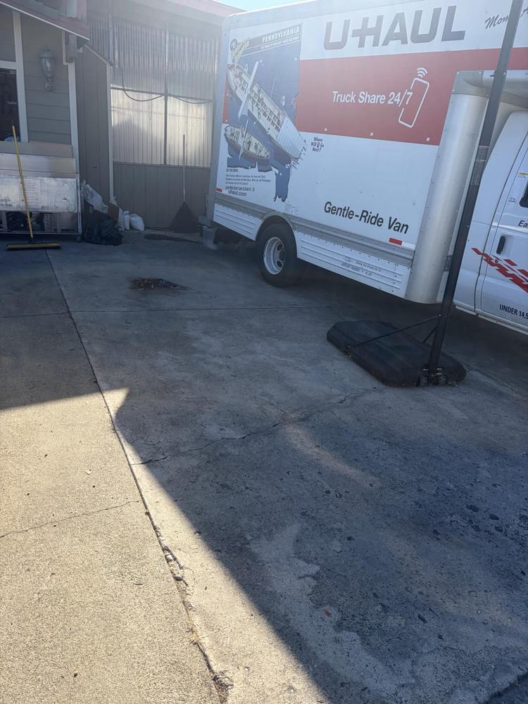 The same driveway swept empty beside the moving van