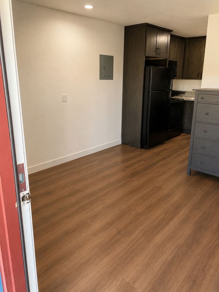 The same room emptied to bare floor, ready for the next tenant
