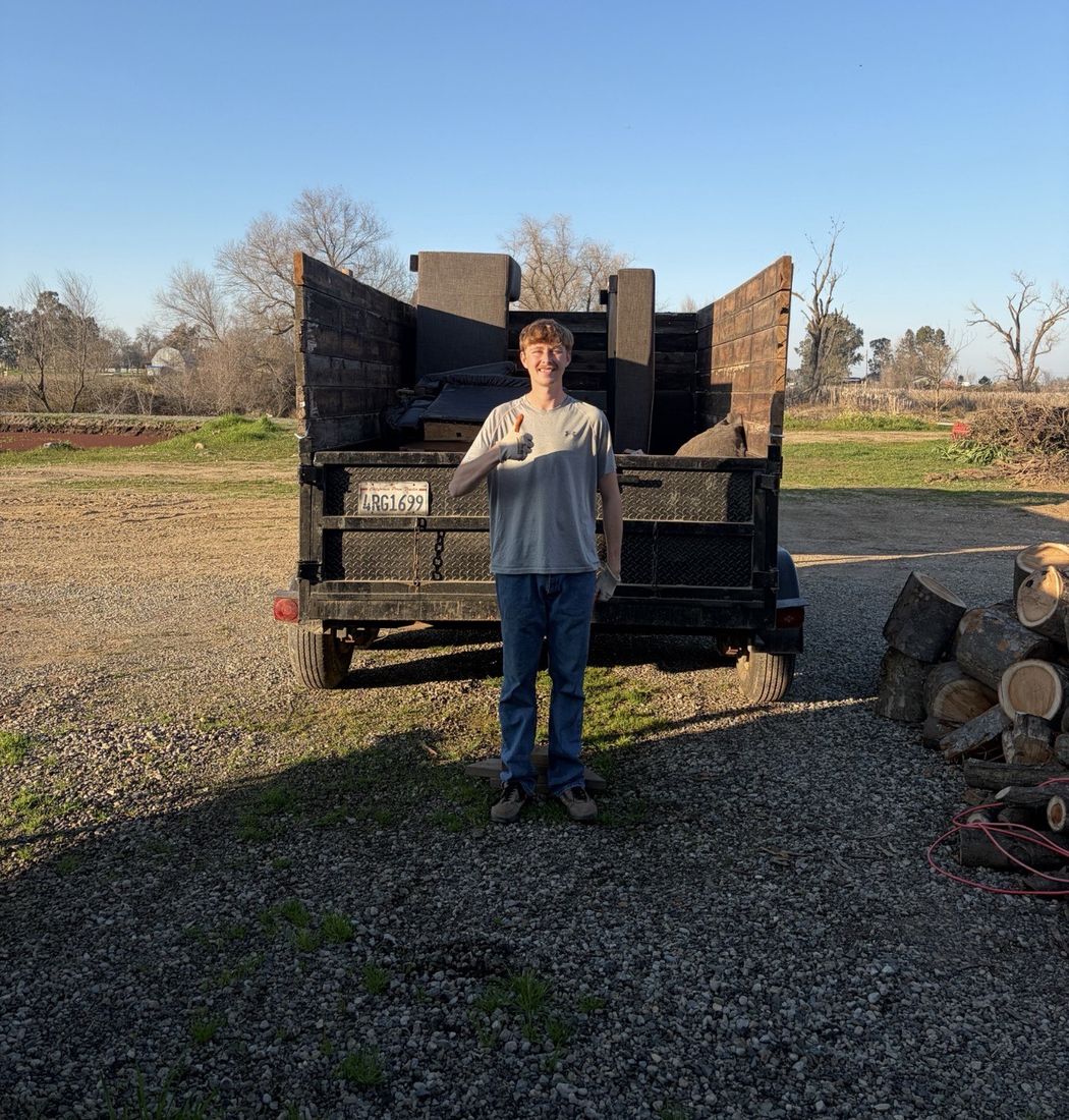 Ty, the owner of Haulin with Ty, with his truck and dump trailer